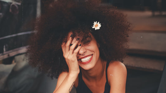 A lady with big hair smiles.